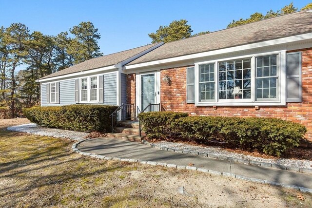 view of front of home with brick siding and a front yard