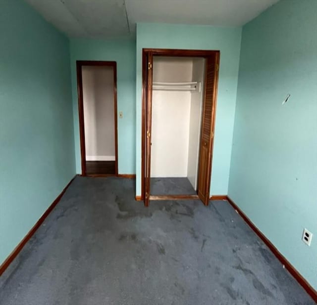 unfurnished bedroom featuring carpet floors and a closet