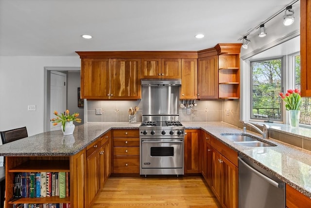 kitchen with brown cabinets, open shelves, a sink, stainless steel appliances, and a peninsula