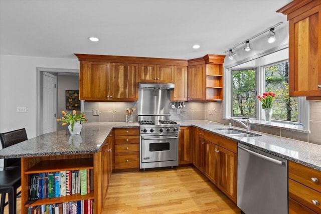kitchen with a sink, open shelves, stainless steel appliances, and brown cabinets