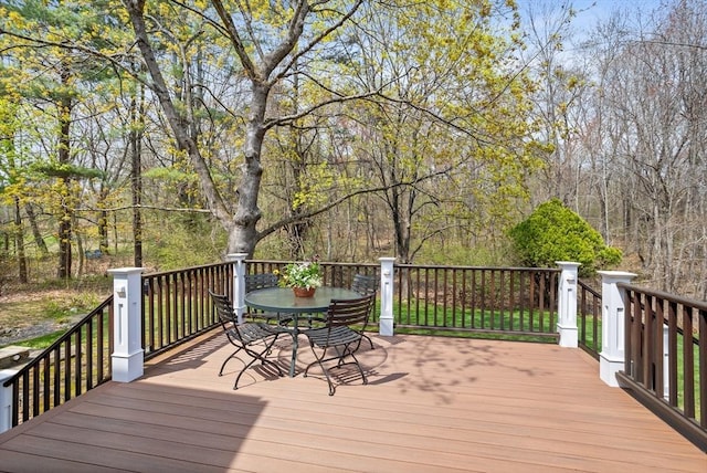 wooden terrace featuring outdoor dining space
