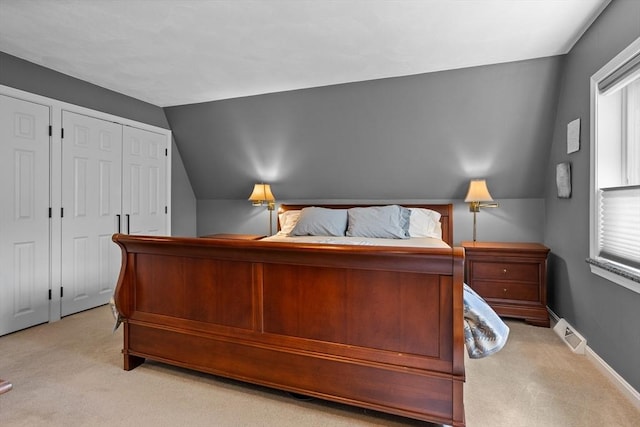 bedroom featuring visible vents, light colored carpet, multiple windows, and lofted ceiling