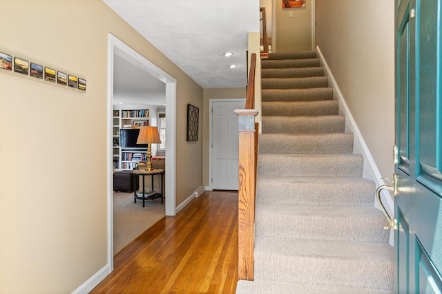 stairs featuring baseboards, recessed lighting, and wood finished floors