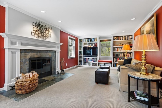 carpeted living area with a tiled fireplace, baseboards, ornamental molding, and recessed lighting