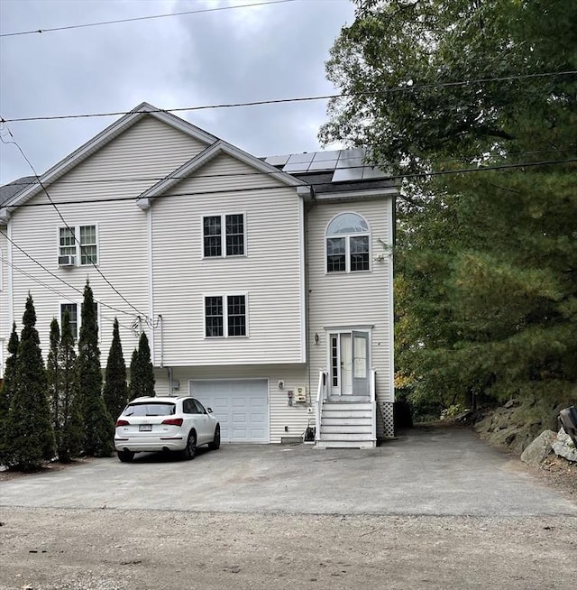 24A Outlook Dr Unit A, Worcester, MA 01602 - view of front of house with driveway, roof mounted solar panels, and an attached garage