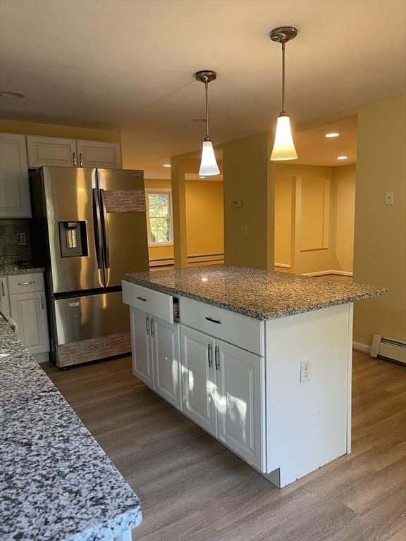 24A Outlook Dr Unit A, Worcester, MA 01602 - kitchen featuring stainless steel refrigerator with ice dispenser, wood finished floors, a kitchen island, and white cabinets
