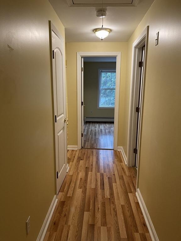 24A Outlook Dr Unit A, Worcester, MA 01602 - hall with attic access, wood finished floors, and a baseboard radiator