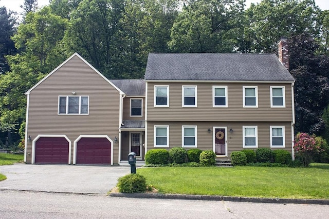 61 Bernice Ave, Leominster, MA 01453 - view of front of home with a chimney, a garage, asphalt driveway, a front lawn, and a shingled roof