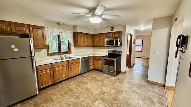 61 Bernice Ave, Leominster, MA 01453 - kitchen featuring appliances with stainless steel finishes, brown cabinets, a ceiling fan, light countertops, and a baseboard radiator