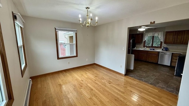 61 Bernice Ave, Leominster, MA 01453 - unfurnished dining area with a baseboard radiator, a chandelier, wood-type flooring, and a ceiling fan