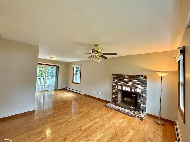 61 Bernice Ave, Leominster, MA 01453 - unfurnished living room with a baseboard heating unit, baseboard heating, a ceiling fan, wood finished floors, and a brick fireplace