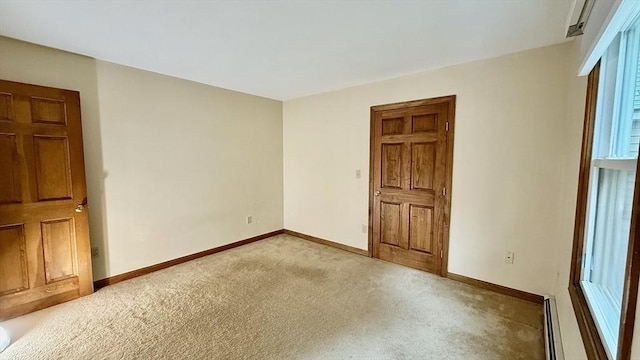 61 Bernice Ave, Leominster, MA 01453 - empty room with light carpet and a baseboard heating unit