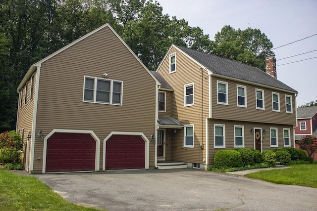 61 Bernice Ave, Leominster, MA 01453 - view of front of home featuring a chimney, a garage, and driveway