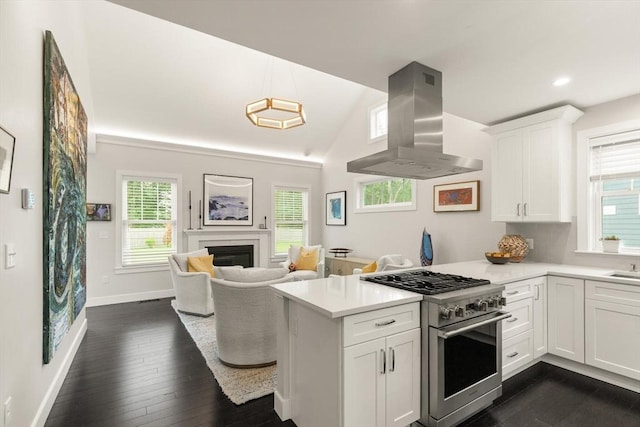 16 Primrose Ln Unit 16, Ipswich, MA 01938 - kitchen with wall chimney exhaust hood, high end stove, dark wood-type flooring, a peninsula, and plenty of natural light