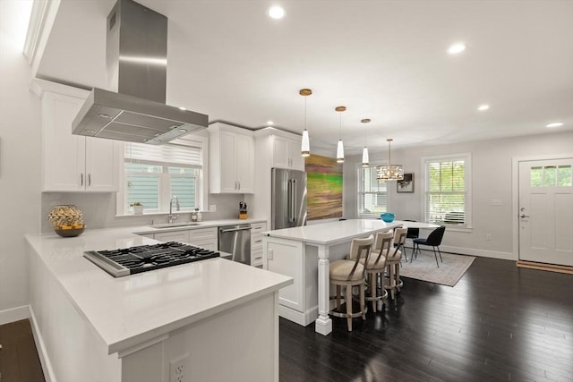 16 Primrose Ln Unit 16, Ipswich, MA 01938 - kitchen with wall chimney range hood, appliances with stainless steel finishes, recessed lighting, a kitchen breakfast bar, and light countertops