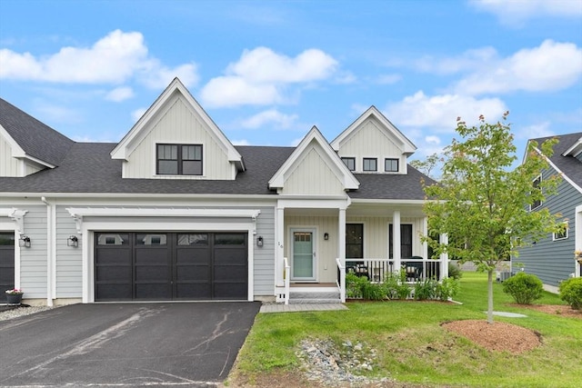16 Primrose Ln Unit 16, Ipswich, MA 01938 - view of front of house featuring a porch, driveway, a front yard, and board and batten siding