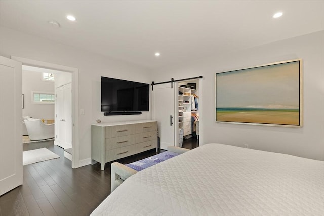 16 Primrose Ln Unit 16, Ipswich, MA 01938 - bedroom featuring a walk in closet, dark wood-style flooring, recessed lighting, a barn door, and a closet