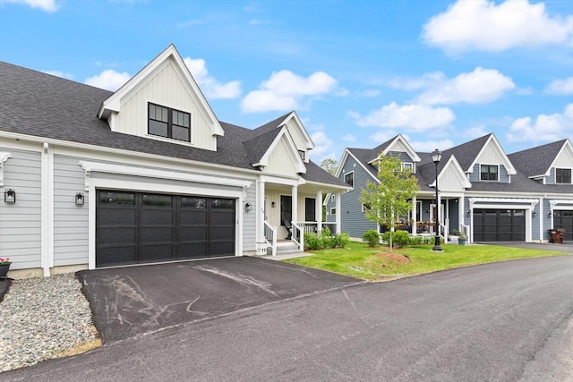 16 Primrose Ln Unit 16, Ipswich, MA 01938 - view of front facade featuring driveway, board and batten siding, a front lawn, a residential view, and covered porch