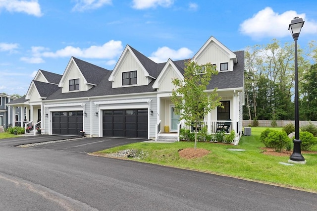 16 Primrose Ln Unit 16, Ipswich, MA 01938 - modern farmhouse featuring a porch, asphalt driveway, a garage, roof with shingles, and board and batten siding