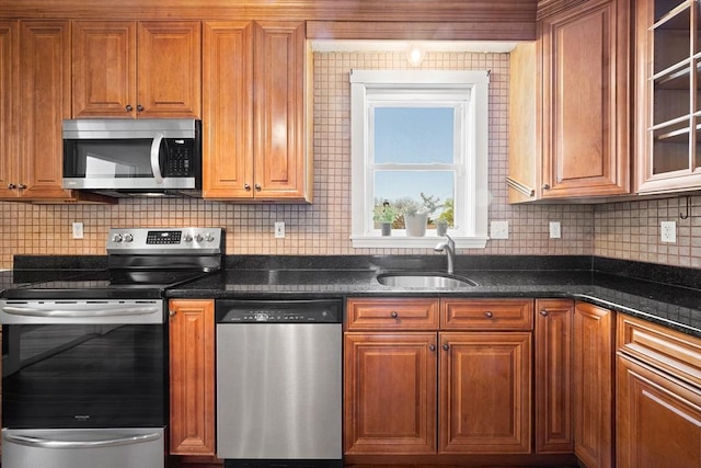 kitchen featuring a sink, brown cabinets, tasteful backsplash, and stainless steel appliances