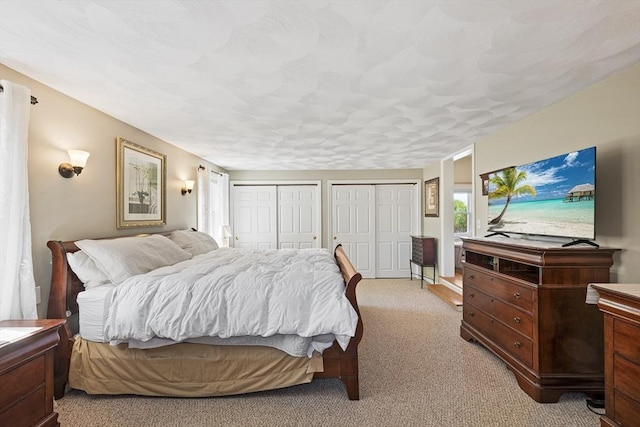 carpeted bedroom with two closets