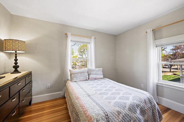 bedroom featuring baseboards and light wood-type flooring