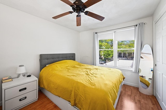 bedroom featuring a ceiling fan and wood finished floors