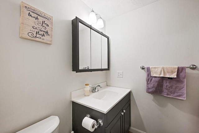 half bath with vanity and toilet