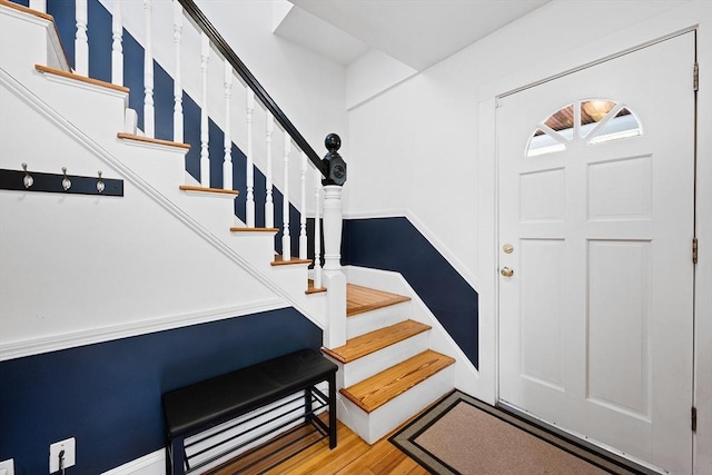 entrance foyer with wood finished floors and stairway
