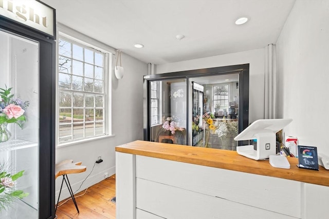 bar featuring recessed lighting, baseboards, and light wood-style floors