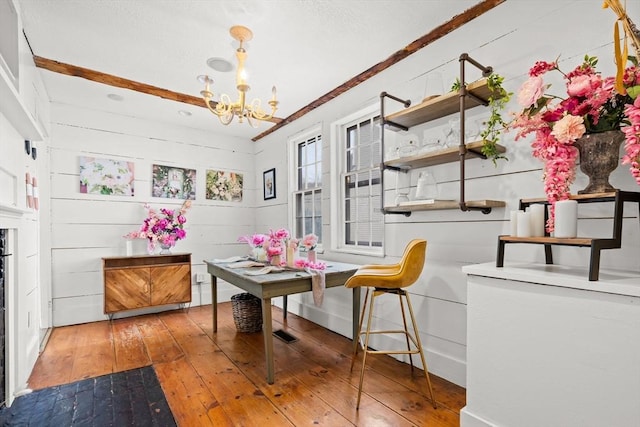 dining room featuring wood-type flooring and a chandelier
