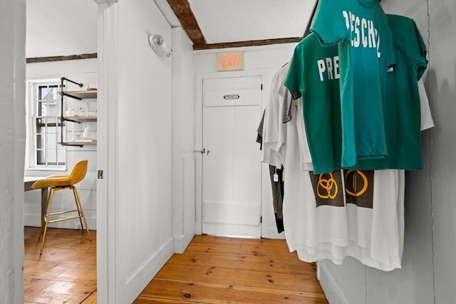 mudroom with a textured ceiling and wood-type flooring