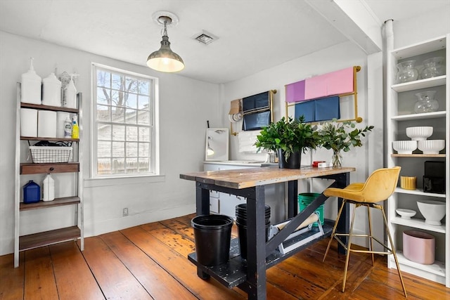 dining space with visible vents and hardwood / wood-style flooring