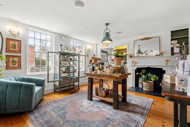 office space with a fireplace, hardwood / wood-style floors, and baseboards