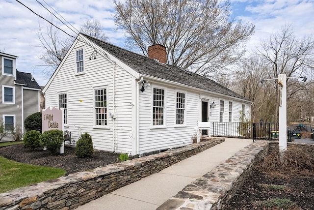 view of side of home featuring a chimney
