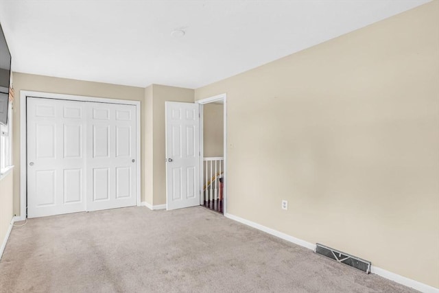 19 Doane Unit 1, Lowell, MA 01851 - unfurnished bedroom with carpet floors, baseboards, and a closet