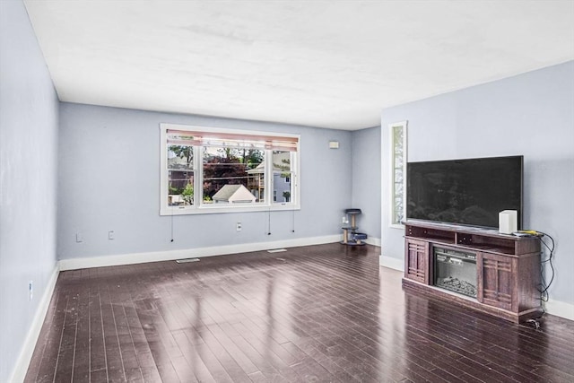 19 Doane Unit 1, Lowell, MA 01851 - unfurnished living room featuring wood finished floors, baseboards, and a glass covered fireplace