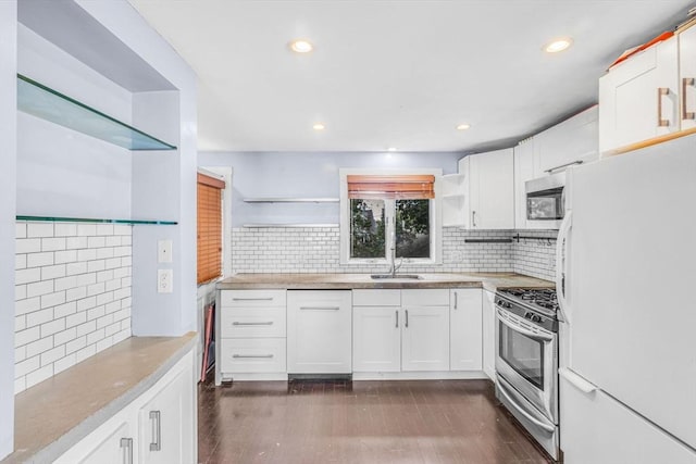 19 Doane Unit 1, Lowell, MA 01851 - kitchen with stainless steel appliances, open shelves, a sink, decorative backsplash, and white cabinets
