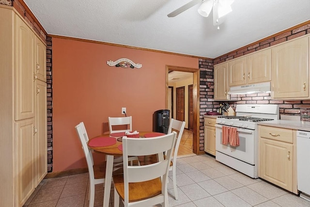 kitchen featuring white appliances, under cabinet range hood, light tile patterned floors, decorative backsplash, and light countertops