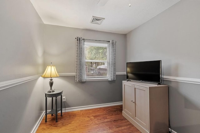 interior space featuring wood finished floors and baseboards