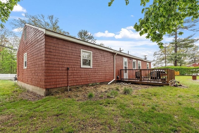 back of house with a deck and a yard