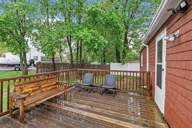 wooden terrace featuring a fenced backyard