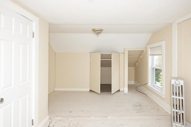 139 Endicott St, Worcester, MA 01610 - unfurnished bedroom featuring lofted ceiling, two closets, and baseboards