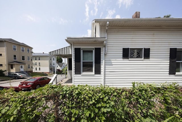 139 Endicott St, Worcester, MA 01610 - view of property exterior with a chimney