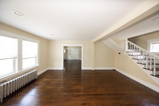 139 Endicott St, Worcester, MA 01610 - unfurnished living room with radiator, baseboards, wood finished floors, and stairs