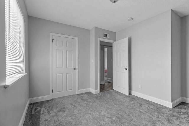 239 Glasgow St Unit 12, Fall River, MA 02721 - unfurnished bedroom with carpet and multiple windows