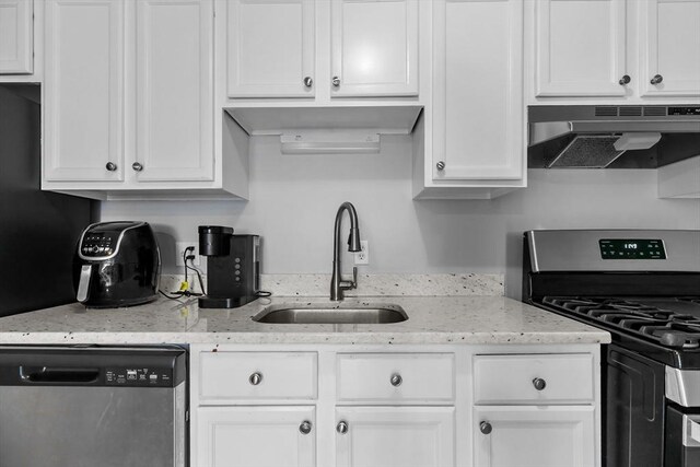 239 Glasgow St Unit 12, Fall River, MA 02721 - kitchen featuring stainless steel appliances, under cabinet range hood, white cabinets, and light stone countertops