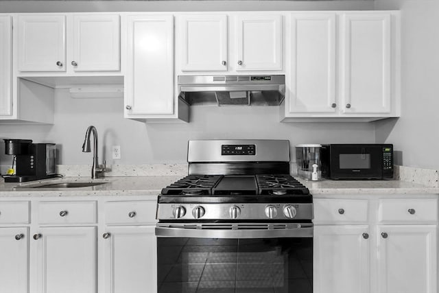 239 Glasgow St Unit 12, Fall River, MA 02721 - kitchen featuring gas stove, under cabinet range hood, black microwave, and white cabinets
