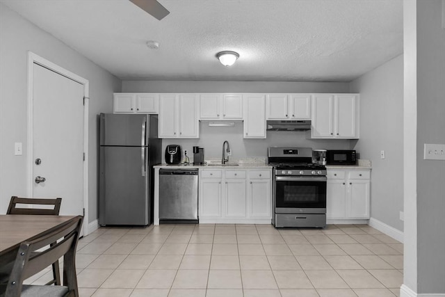 239 Glasgow St Unit 12, Fall River, MA 02721 - kitchen featuring stainless steel appliances, under cabinet range hood, white cabinetry, and a textured ceiling