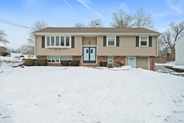 raised ranch featuring brick siding